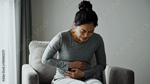 Woman experiencing stomach pain or discomfort.