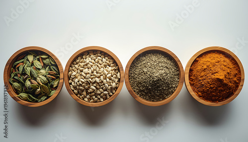 Spices and herbs in wooden bowls on white background, top view