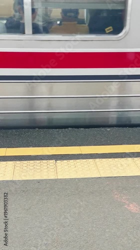 Commuter Train Doors Slowly Moving on Station Platform with Yellow Tactile Safety Tiles