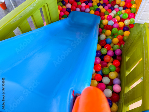 Blue Plastic Slide Leading into a Colorful Ball Pit in a Children Indoor Playground