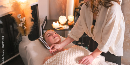 Принти на полотні Facial massage and tuning fork sound therapy in candlelit spa, holistic skincare wellness ritual, relaxation and stress relief, self care, energy balance