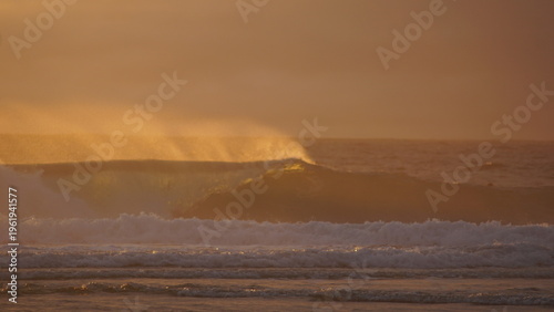 A serene view of ocean waves catching the warm glow of a golden sunset, creating a tranquil and reflective atmosphere, perfect for evoking a sense of peace and calm.