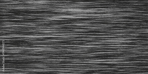 Dark macro detail of a textured black fabric and leather material background featuring a striped wood grain pattern on an old dark brown wooden surface