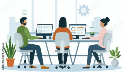 Modern office environment with three colleagues working on computers at a shared desk