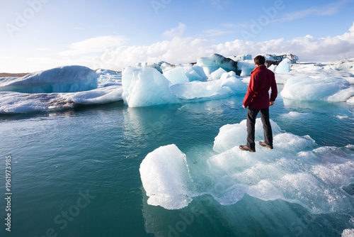 фотографія Adventurer standing on glacial ice at Jökulsárlón, Iceland