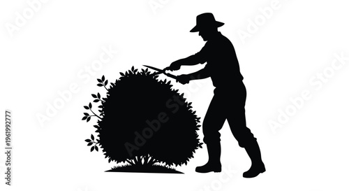 Gardener trimming a bush with shears a striking black silhouette