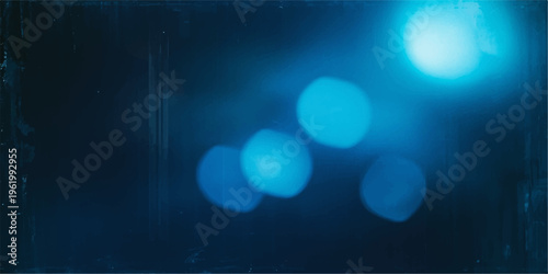 Bright blue abstract background featuring glowing bokeh particles and shiny defocused lights with a blurred glitter pattern for a festive holiday design backdrop