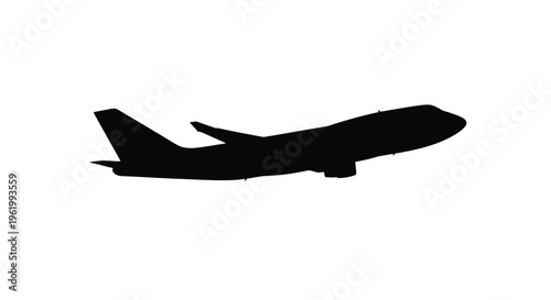 Jet airplane in flight a stark black shape against white silhouette