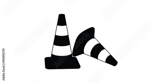 Two traffic cones rest against each other black and white silhouette
