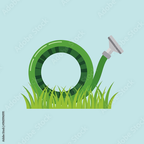 A green hose coiled on grass with nozzle