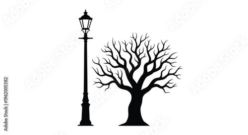 A stark lamppost and bare tree composition in black silhouette