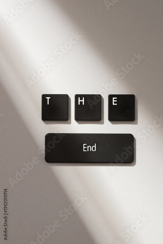 Photos Black keyboard keys spelling THE End on gray background with soft shadow, symbolizing conclusion or finale