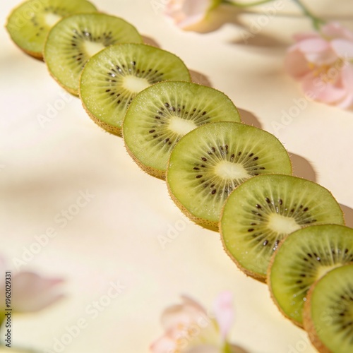 Vertical arrangement of hyper-realistic kiwi slices against soft beige background with copy space