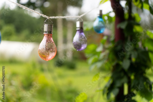 decoration with burning lamps on wooden pier. Patio decorated with electric lamps as garland,wooden terrace near lake, pier. romantic atmosphere .Romantic evening.wedding ceremony