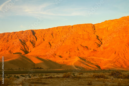 Terra rossa. Sunset landscape. Tropical red earth (lateritic soil). Red cliffs above the winter desert (rubble-loam), the aggravation of the red afterglow of scarlet sunset. Iran