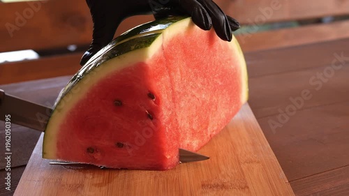  Watermelon slicing on wooden board watermelon as healthy summer snack and natural food concept Chef preparing watermelon for fruit dessert food blogger filming healthy lifestyle and nutrition concept