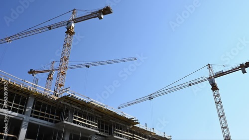 Modern High-Rise Construction with Multiple Yellow Tower Cranes