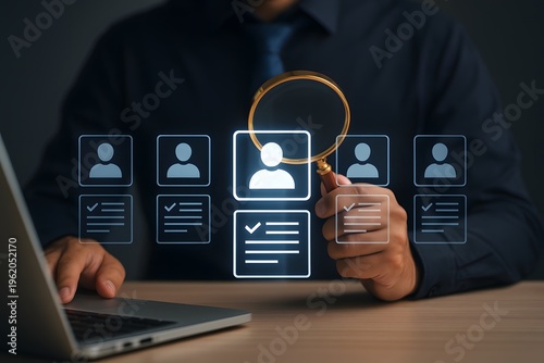 Businessman uses a magnifying glass to highlight a glowing profile icon, signifying a focused talent search or recruitment selection process.