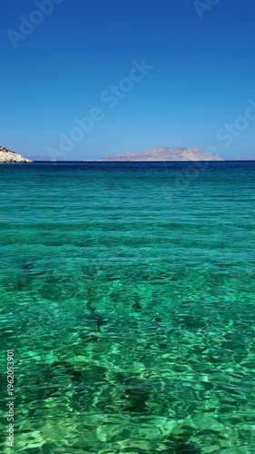 View of a vertical footage of the turquoise see through waters of the Agia Theodoti dream beach in Ios Greece