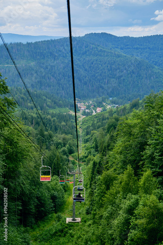 Man and Dog Riding Chairlift in Mountains