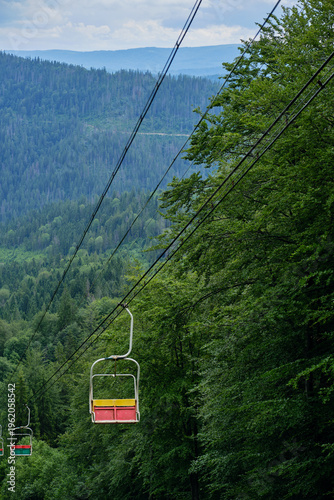 Empty Chairlift Descending Forest Slope