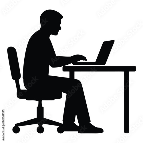 Silhouette of man sitting at desk working on laptop