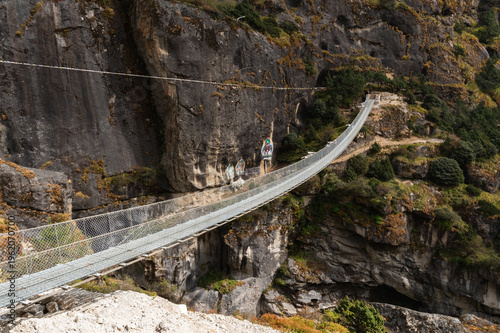 Suspension bridge over Bhotekoshi river Nepal mountain canyon adventure travel landscape