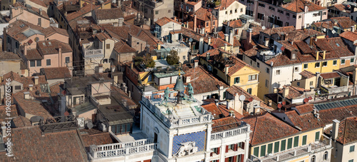 Historic bell tower rising above Venetian rooftops