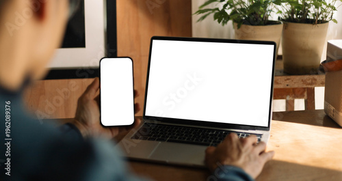 computer screen,mobile phone blank mockup.work using laptop texting cell phone.white background for advertising,contact business search information on desk.marketing,design