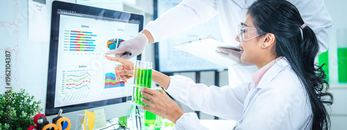 Scientists team discussing and analyzing sustainability data in a modern laboratory, making data-driven decisions for green energy solutions, climate action, and net zero innovation strategies.