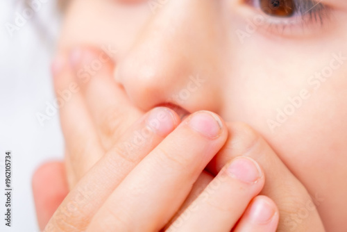 child covering mouth with hands, expressing fear speaking, shyness, social anxiety, struggle begin articulation, expressing silence, suppress cough or sneeze, Childhood shyness and secret keeping