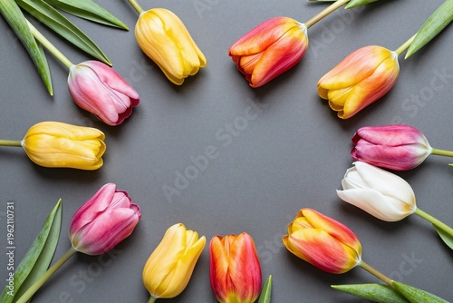 A bunch of colorful flowers on a gray background