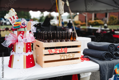 Foto Carnival ring toss game with glass bottles in a wooden crate