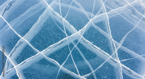 Close-up view of intricate cracks forming geometric patterns on a frozen blue ice surface.
