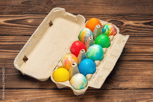 Colorful Easter eggs in an egg carton, perfect for spring holidays and celebrations