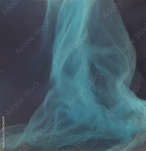 Soft blue tulle blur motion on dark background. Abstract airy cyan smoke mist fluidity overlay.