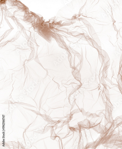 Crumpled sepia tulle fabric texture isolated on white background.  Abstract study of nude tulle net transparent material.