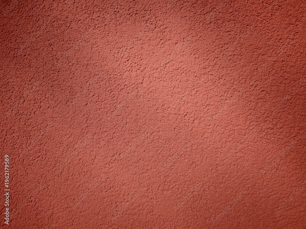 Fototapeta premium Textured wall surface in a warm shade observed during daylight hours