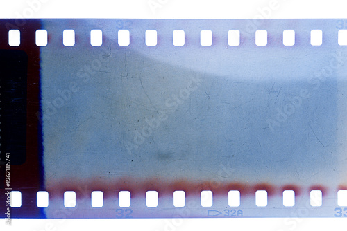 Dusty and grungy 35mm film texture or surface. Perforated scratched camera film isolated on white background.