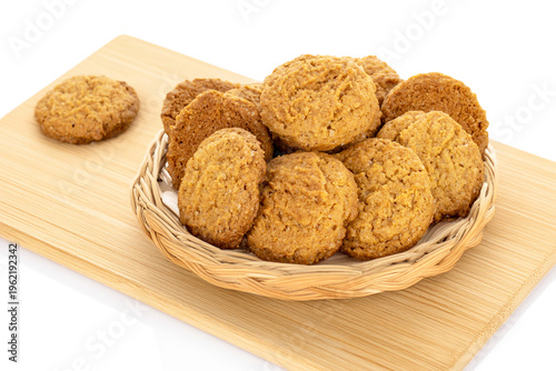 Oatmeal cookies with kitchen utensils isolated on white background, close-up.