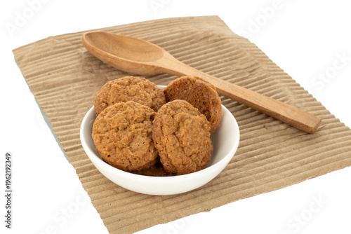 Oatmeal cookies with kitchen utensils isolated on white background, close-up.