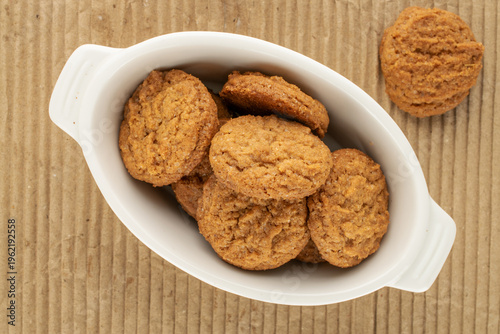 Oatmeal cookies with kitchen utensils on kraft paper, close-up. Top view.