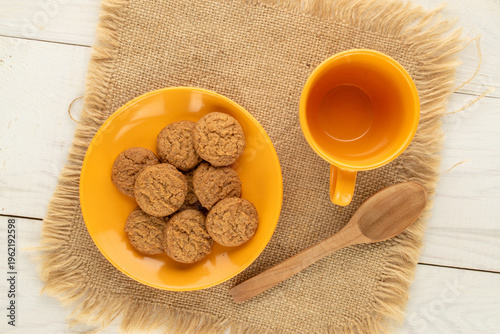 Oatmeal cookies with kitchen utensils on a wooden table, close-up. Top view.