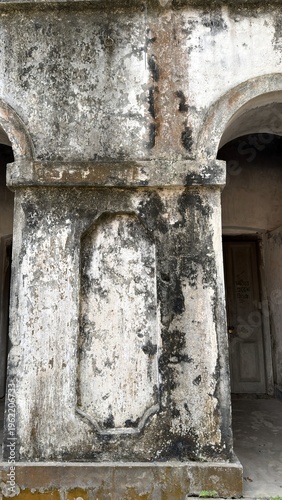 Fotografie Heavily distressed archways and recessed panel on an ancient wall