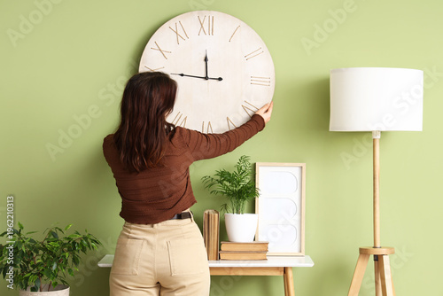 Young woman hanging big clo...