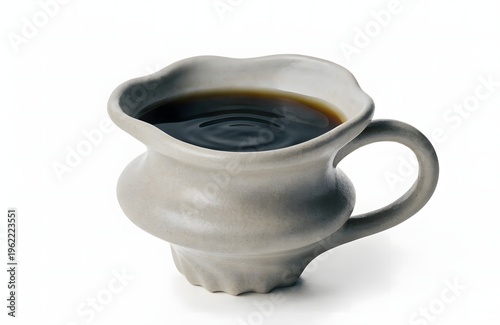 A gray ceramic coffee creamer with a handle on a white background