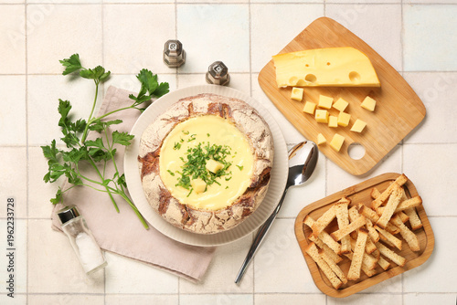 Cheese soup in bread bowl w...