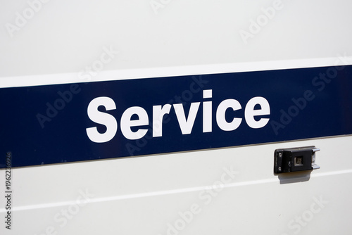 Tableau sur toile A horizontal dark blue stripe with the word Service in white on a white technical and professional van