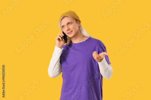 Young blonde man in hat tal...