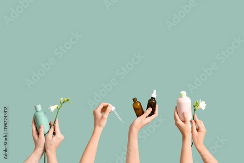 Many female hands with bott...
